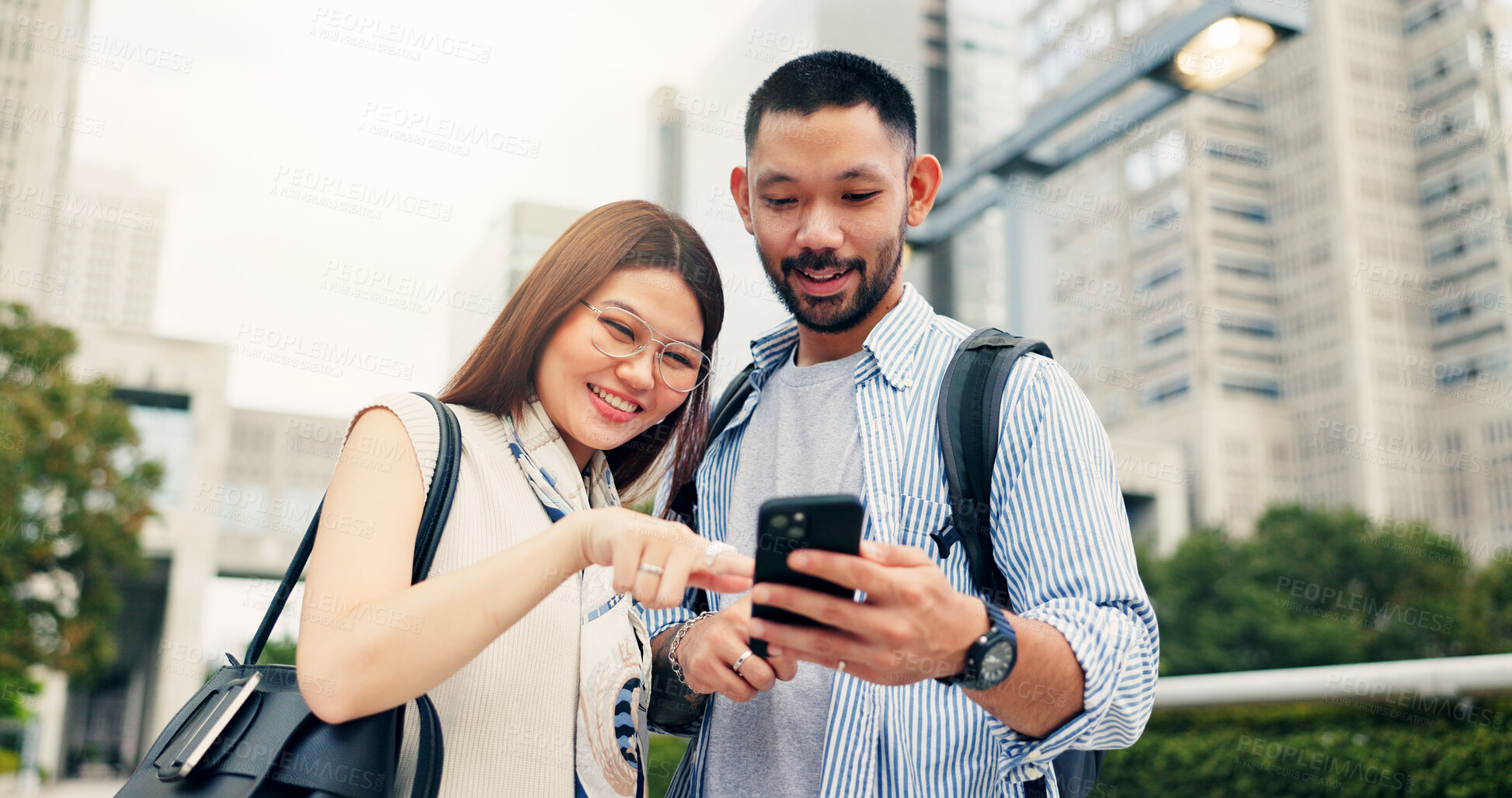 Buy stock photo Couple, smartphone and travel with direction in city, click and mobile app for location, landmark and smile in street. People, man and woman with phone, talking and search on urban sidewalk in Japan