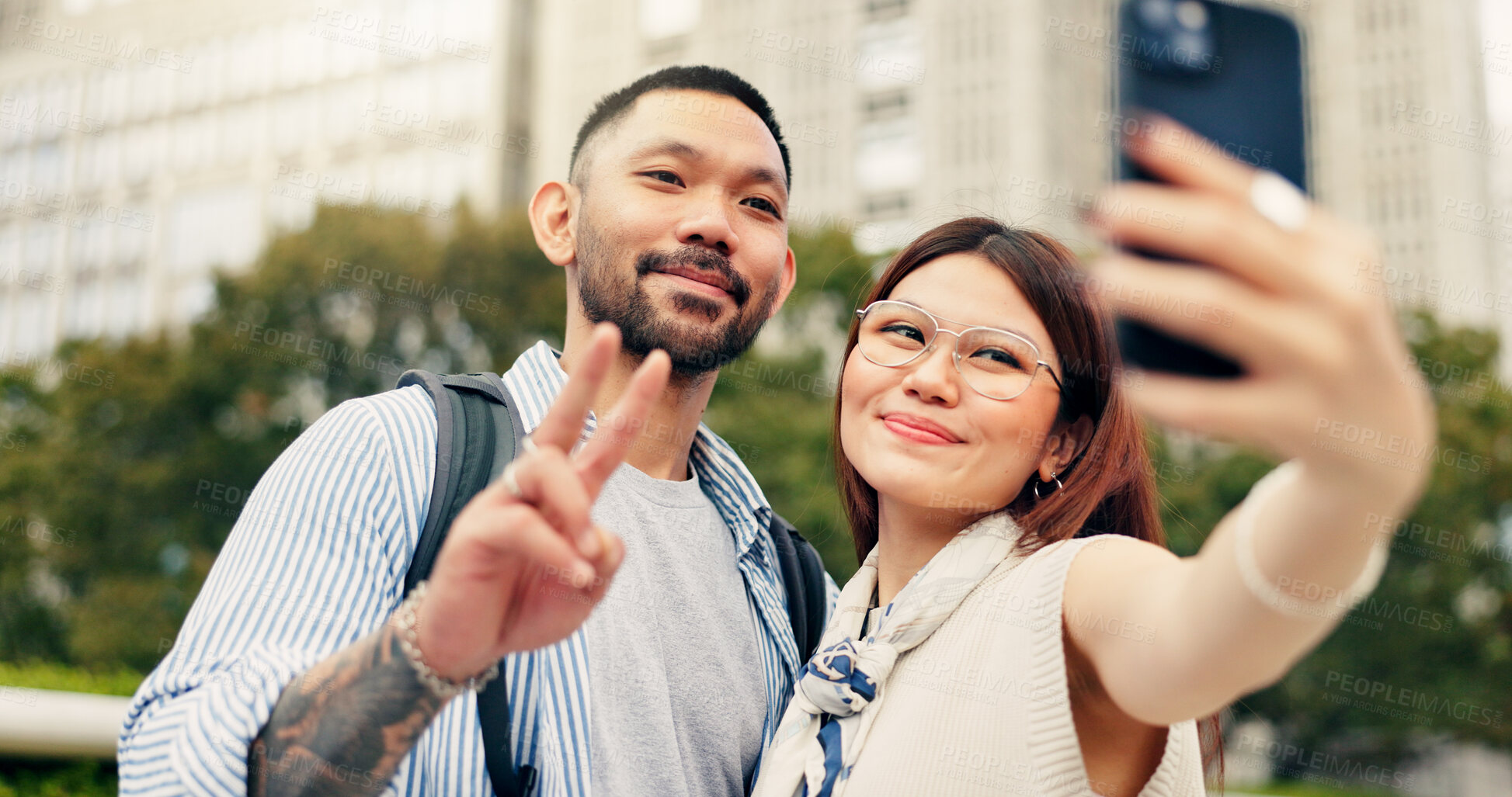 Buy stock photo Couple, peace sign and selfie on trip to city of Japan, love and bonding on honeymoon vacation. Happy people, hug and emoji for support on holiday in urban town, media update and digital photography