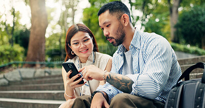 Buy stock photo Couple, phone and happy on travel at park on stairs, click and decision for hotel booking with mobile app. People, man and woman with smartphone, reading and notification on social network in Japan