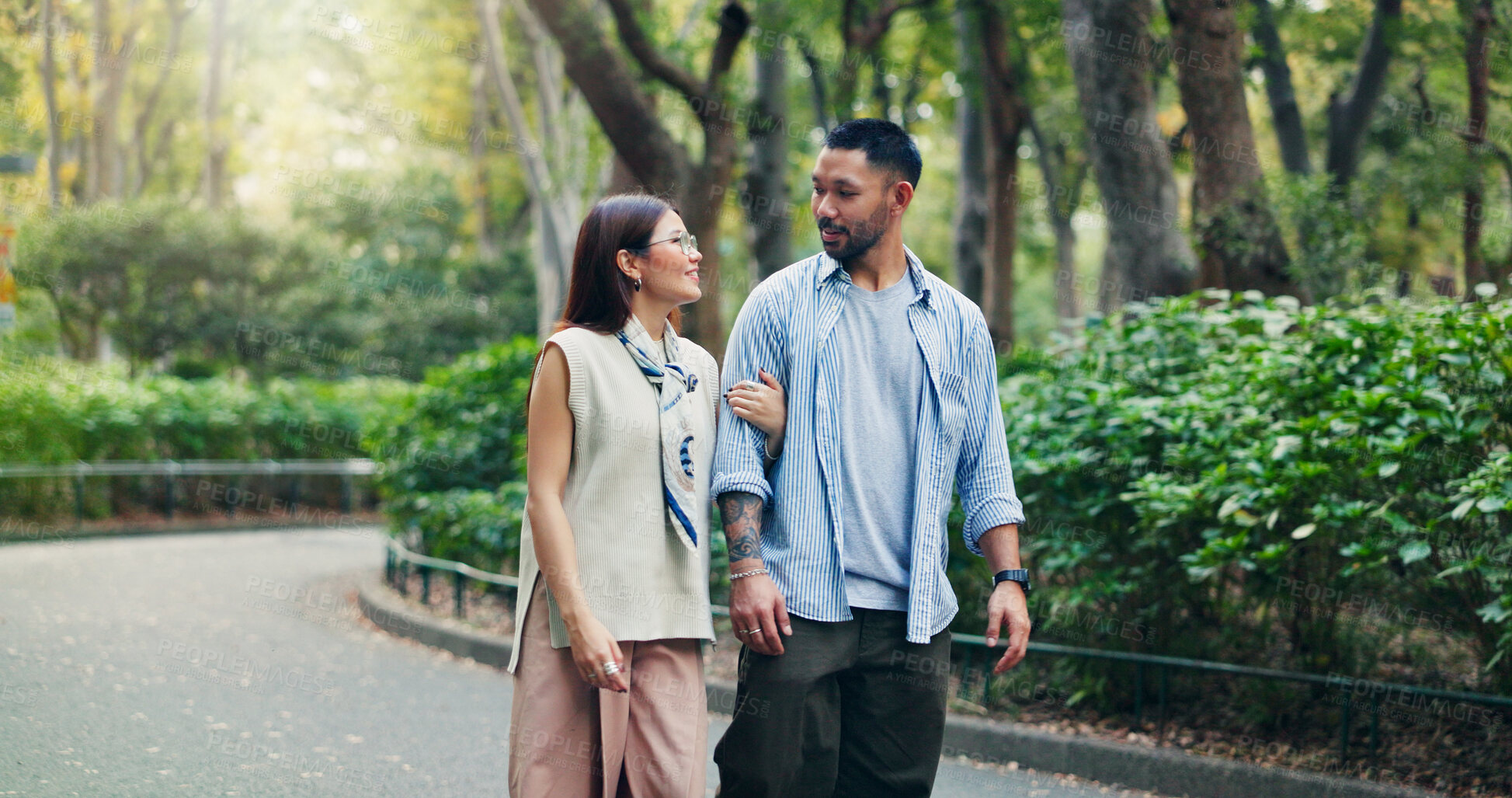 Buy stock photo Couple, conversation and walking in calm park of Japan, love and bonding on honeymoon vacation. People, security and outdoor support on holiday in nature, travel together and explore relationship