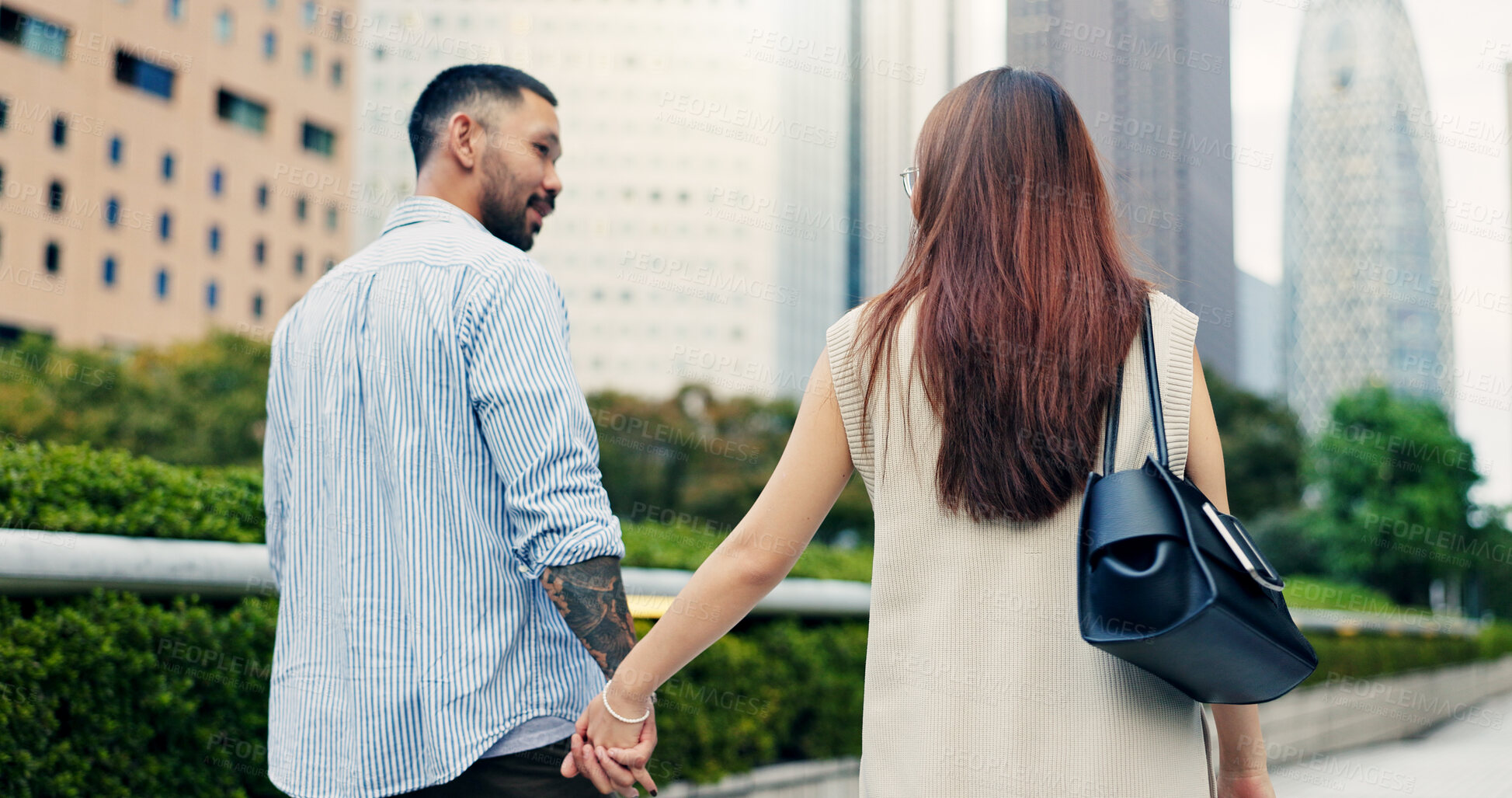 Buy stock photo Couple, holding hands and walking in urban town of Japan, love and bonding on honeymoon vacation. People, security and outdoor support on holiday in city, travel together and explore relationship