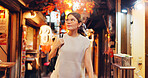 Night, street market and search with Japanese woman in city on vacation for shopping, travel and festival. Culture, traditional holiday and walking with person for urban, tourism or heritage