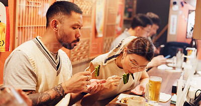 Buy stock photo Couple, eating and restaurant for Asian food in city for nutrition, dinner and healthy meal. Japanese woman, man and bonding together for culture, cuisine and hungry for recipe or date night in Japan