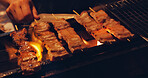 Pork skewer, hands and Japanese street food on grill, outdoor barbecue or meat kebab on fire for dinner. Asian cuisine, festival culture and person cooking yakiton on charcoal flames at local market