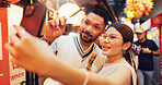 Couple, selfie and market with Asian food in street for romantic getaway, trip or anniversary. Happy people, mobile phone and bonding together for holiday, vacation and tourism on date night in Japan