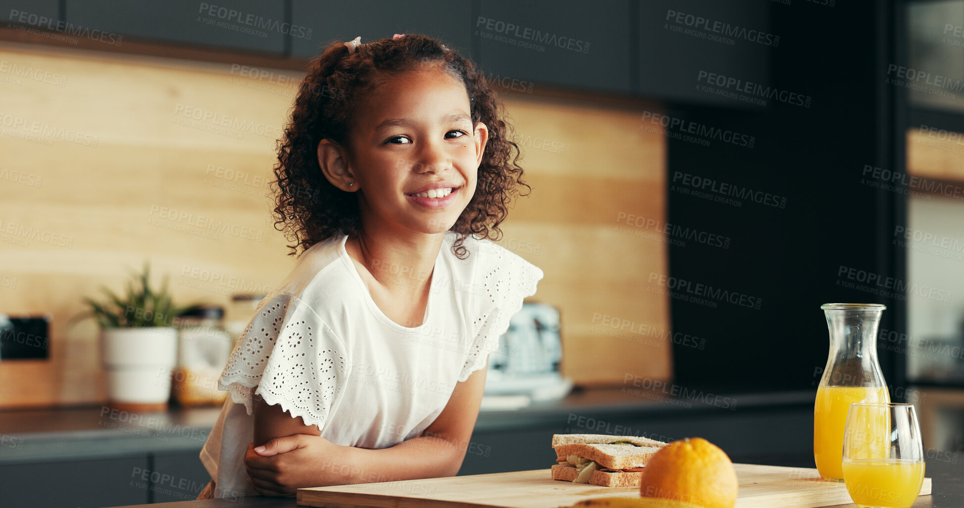 Buy stock photo Child, smile and portrait in home with breakfast, orange juice or relax in morning. Young girl, sandwich or happy in kitchen with food, fresh drink or nutrition with vitamin C for development in Cuba