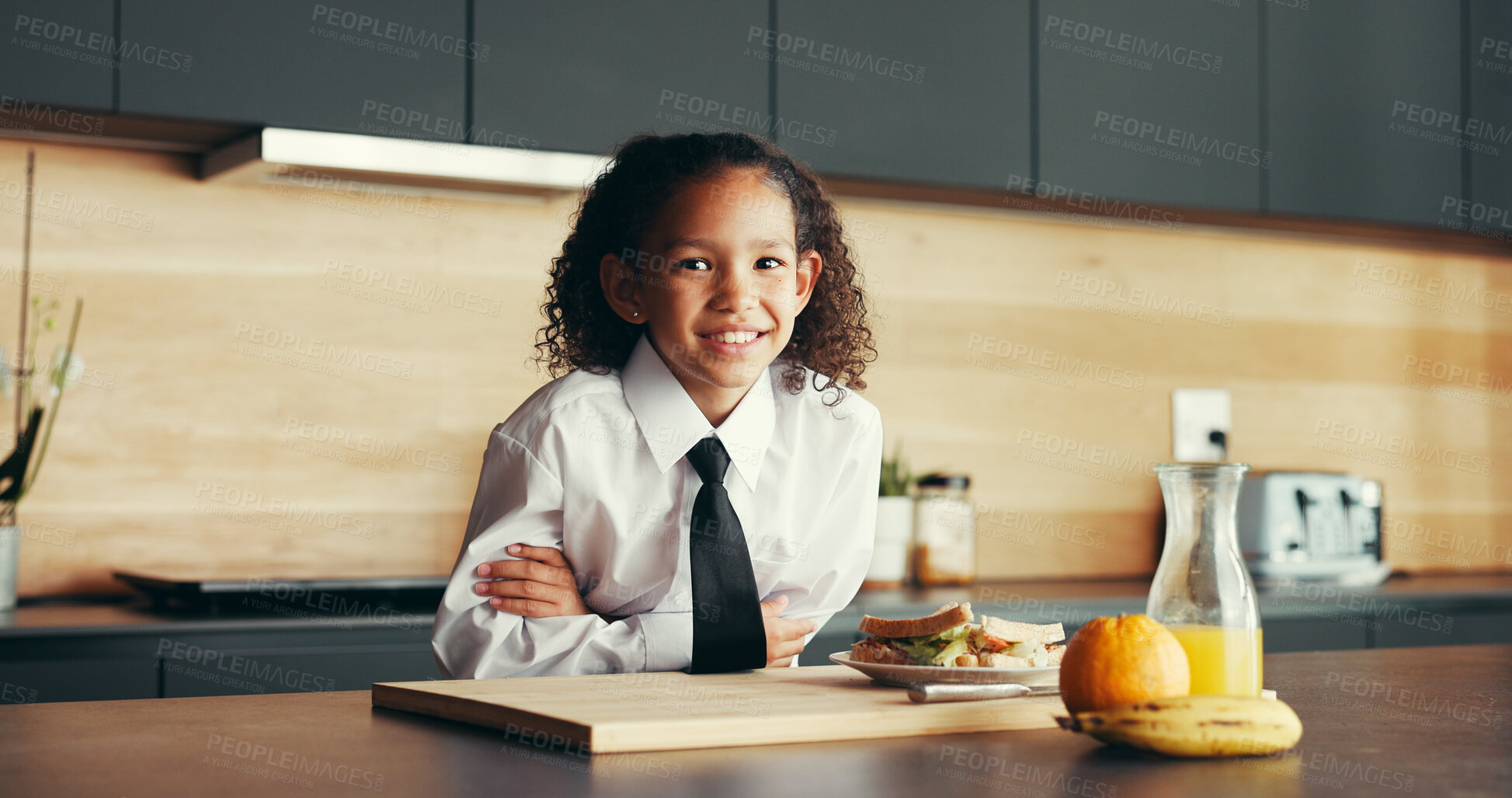 Buy stock photo School, portrait and girl in kitchen with breakfast, smile and confidence in uniform for child development. Morning, wellness and happy face of student in home with sandwich, juice and healthy diet