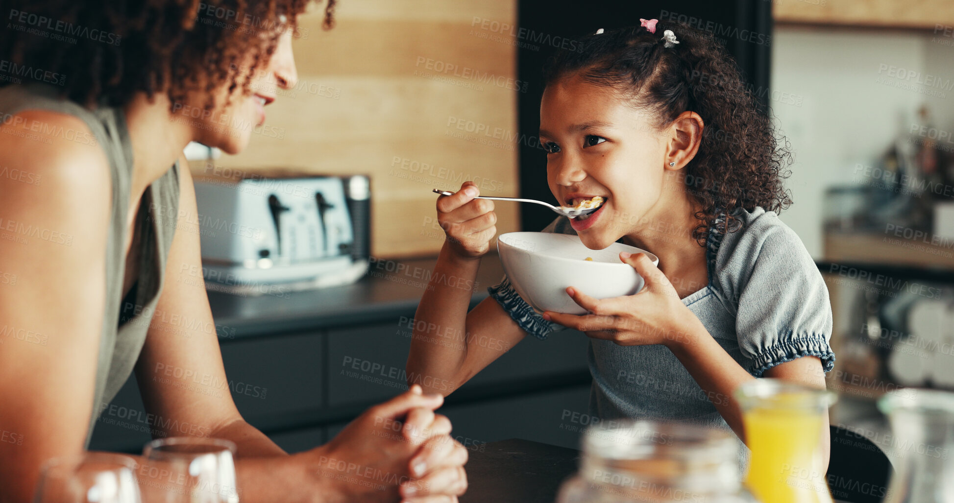 Buy stock photo Cereal, eating or mom talking to girl for love, development or bonding together in morning. Child, mother or daughter with breakfast in family house kitchen for food, meal or nutrition for wellness