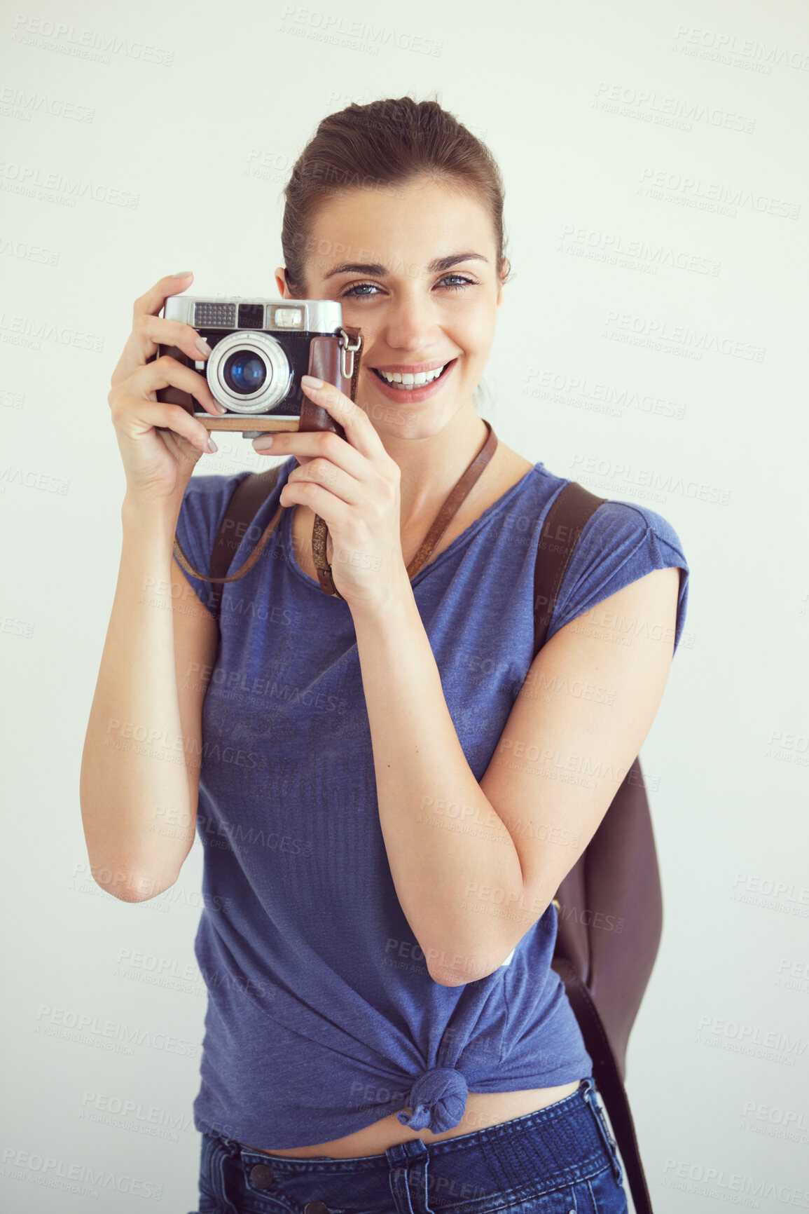 Buy stock photo Portrait, smile and camera with a woman photographer in studio on a white background for travel or tourism. Creative, art and a happy young person looking confident with retro or vintage photography