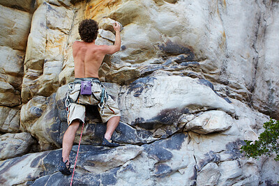 Buy stock photo Man, rock climbing and rope hanging on mountain boulder for challenge, risk performance on stone. Male person, exercise and outdoor cardio gear or courage as fearless athlete, brave danger on cliff