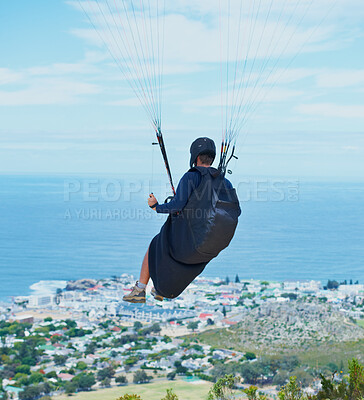 Buy stock photo Man, parachute or paragliding in blue sky for ocean view, flight freedom or adventure in extreme sport. Pilot, nature and fearless in outdoor fitness for health, sports and wellness with glide in air