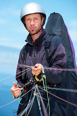 Buy stock photo Paragliding, parachute and man with preparation in nature, strings and exercise for health support. Athlete, training or fitness for outdoor with safety harness, helmet or equipment in countryside