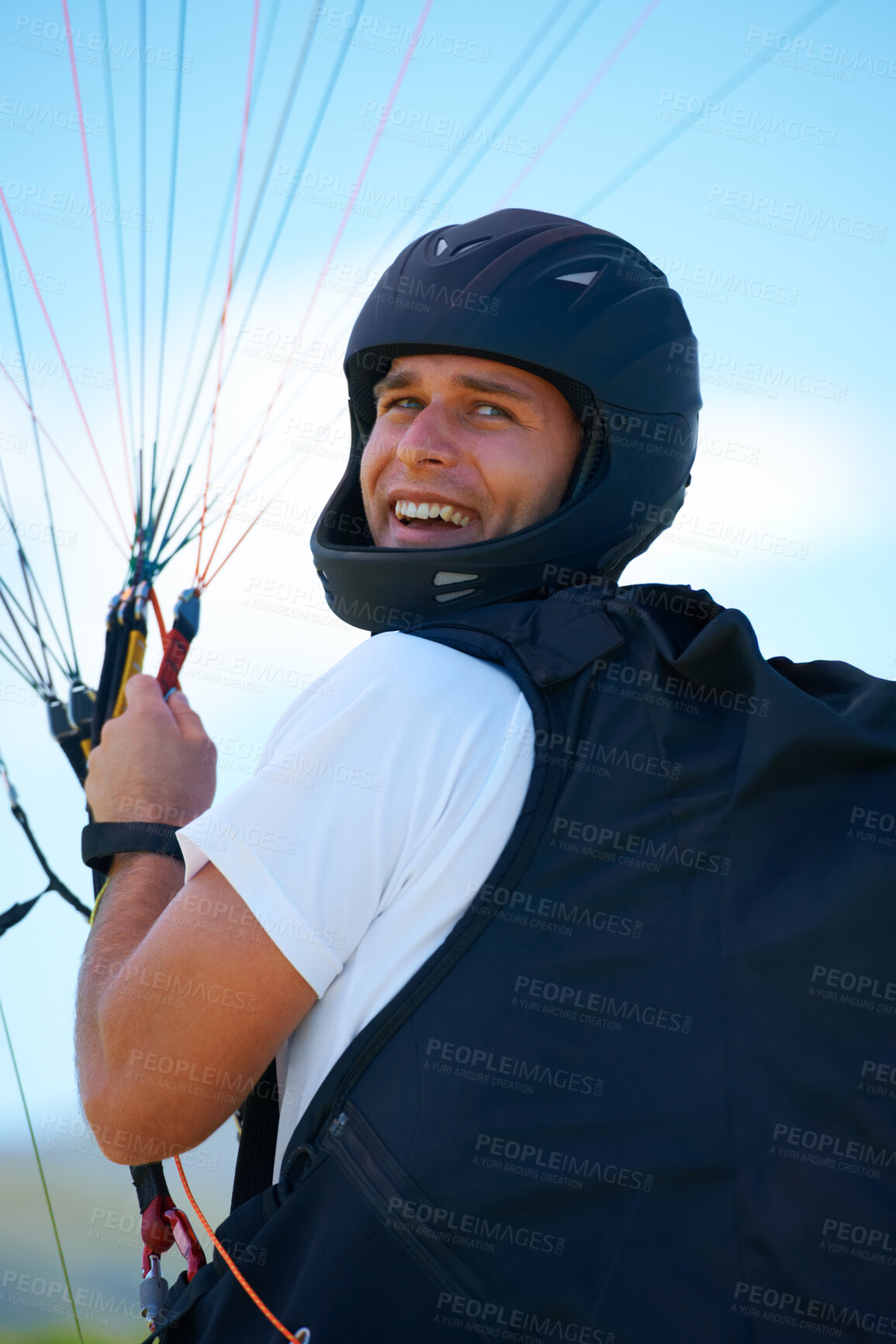 Buy stock photo Man, parachute or launch in nature for sport, happy or exercise for healthy adventure for extreme fitness. Person, strings or smile for outdoor fun in wellness, helmet or safety gear in countryside