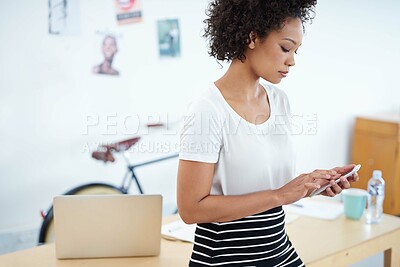 Buy stock photo Young woman, mobile and office planning for social media, online and communication in creative job or magazine agency. African worker, employee or business person typing and reading on her phone