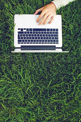 Buy stock photo Top view, hands and freelancer with laptop on grass for writing article on grazing management and plant recovery. Remote work, eco writer or tech for blog story on sustainability of natural resources