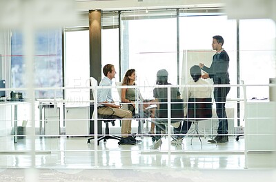 Buy stock photo Shot of a group of colleagues brainstorming in an office