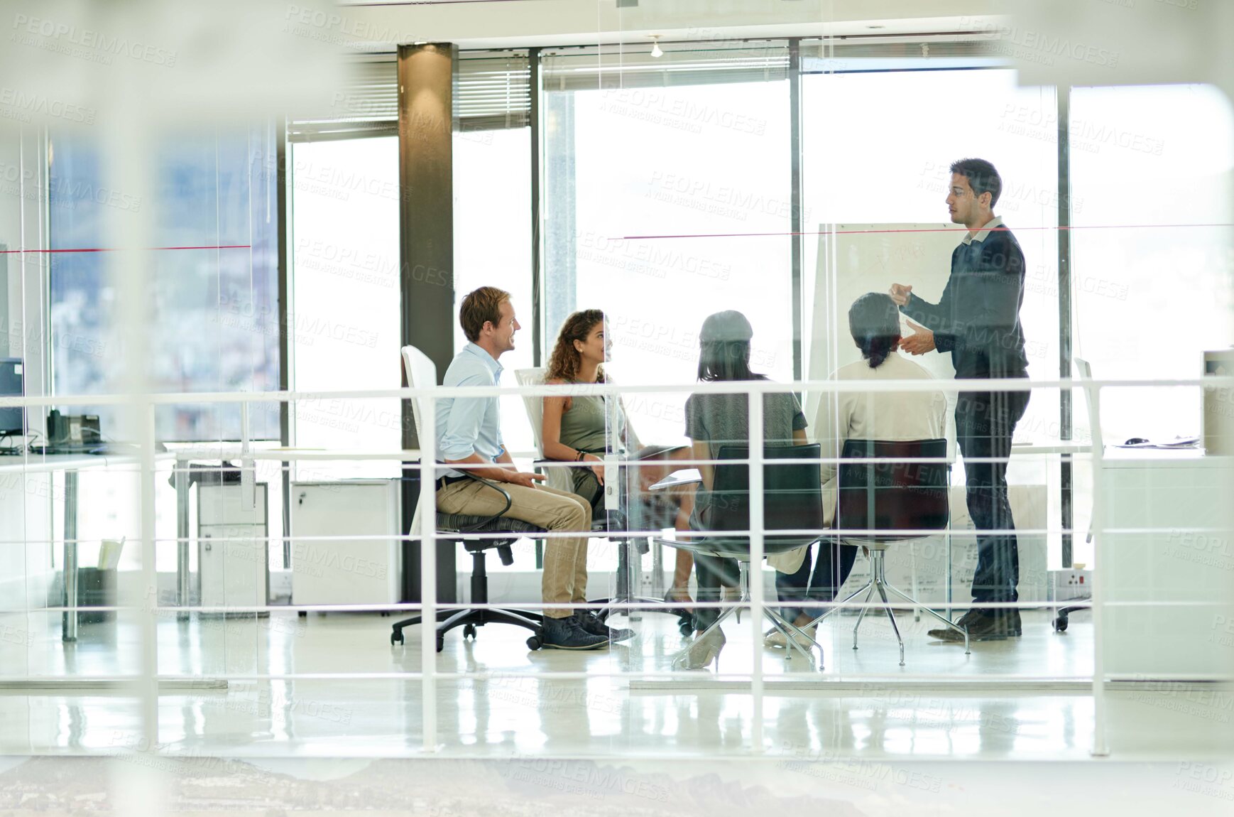 Buy stock photo Shot of a group of colleagues brainstorming in an office