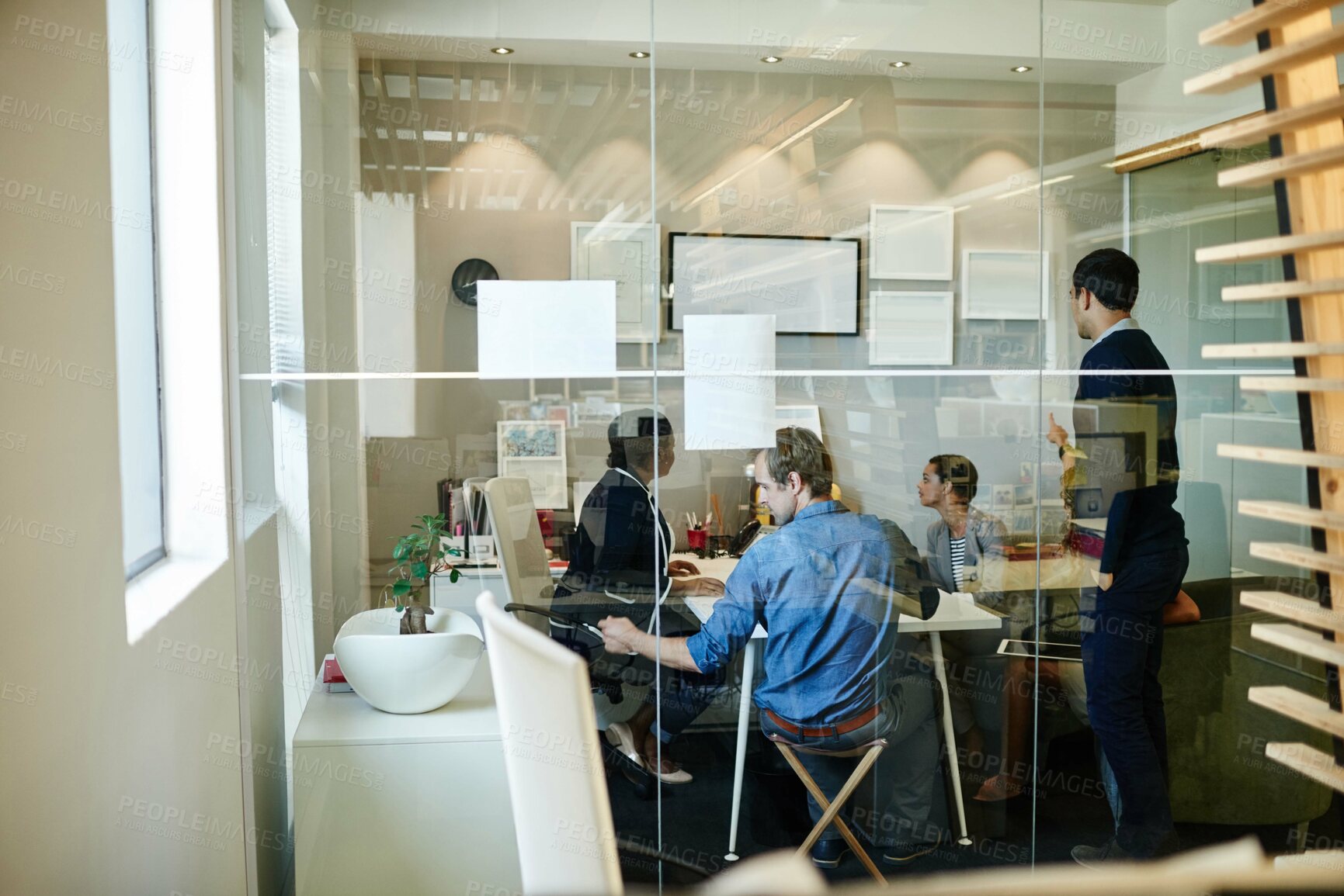 Buy stock photo Shot of a group of colleagues working together in an office