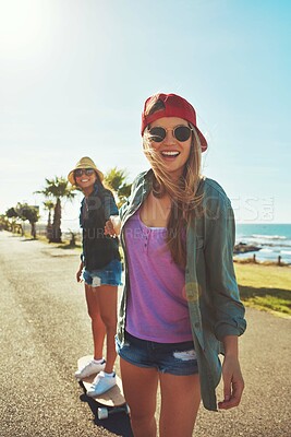 Buy stock photo Happy, friends or women by beach with skateboard for holiday break, learning or vacation trip. Helping hand, smile or people on promenade laughing for outdoor activity support, bonding or adventure