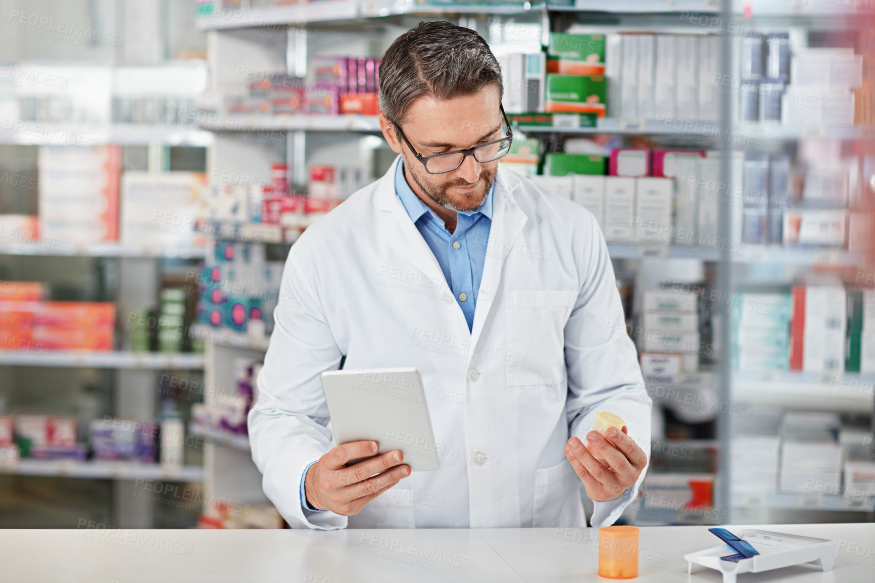 Buy stock photo Tablet, search and man in pharmacy with pills, healthcare and prescription medicine in store. Health, professional service and mature pharmacist at counter with medical advice, digital app and drugs