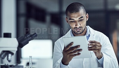 Buy stock photo Shot of a scientist recording his findings on a digital tablet