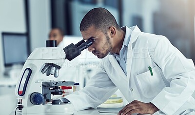 Buy stock photo Cropped shot of a young male scientist working in his lab