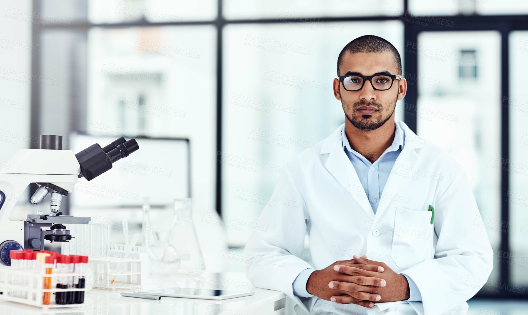 Buy stock photo Cropped shot of a young male scientist working in his lab