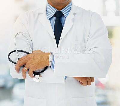 Buy stock photo Cropped shot of a doctor holding a stethoscope and folding his arms