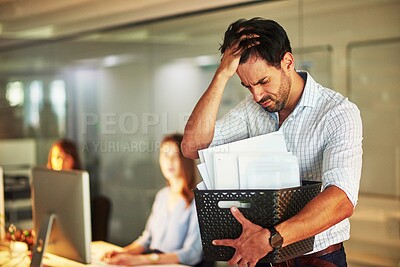 Buy stock photo Shot of a stressed businessman holding his box of possessions after getting fired from his job