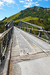 Road, bridge and construction outdoor with mountain, forest and rural street in California with asphalt. Travel, countryside and transportation way with drive, trip and path for motorway with wood