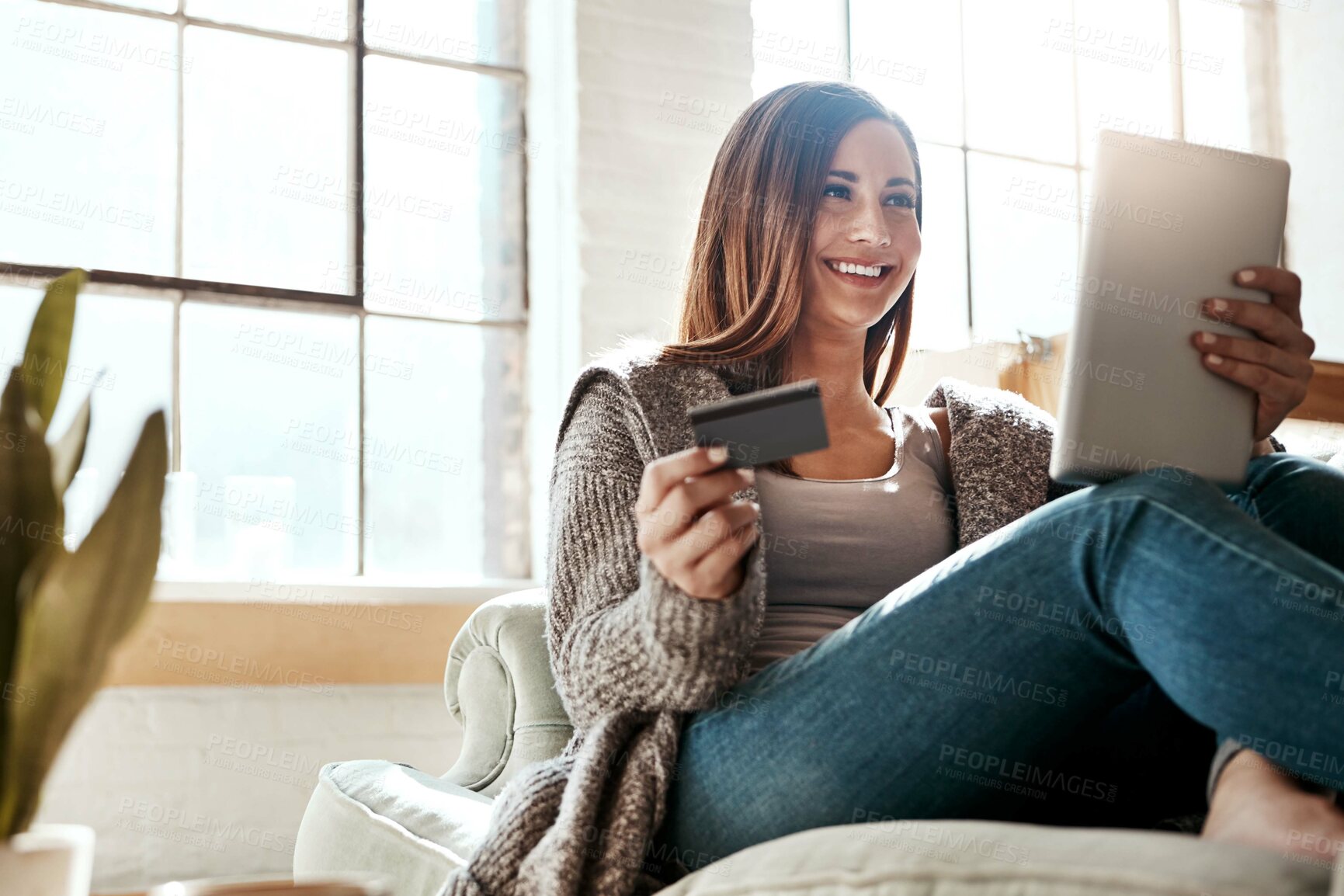 Buy stock photo Online shopping, credit card and woman with digital tablet on a sofa, relax and smile while checking booking online.  Ecommerce, girl and card for banking, credit score or subscription in living room
