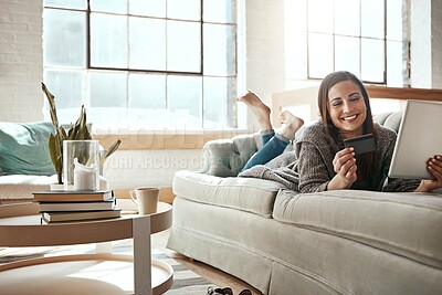 Buy stock photo Relax, online shopping and credit card, happy woman on sofa on ecommerce app with tablet and internet banking in home. Technology, cashback payment and girl on couch on retail website or digital shop