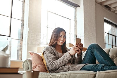 Buy stock photo Relax, phone and woman on a sofa, happy and texting on social media while resting in her home. Girl, smartphone and app for chatting, online dating and internet, search and streaming in a living room