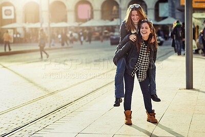 Buy stock photo Friends, piggyback and outdoor portrait in city, bonding and travel to Berlin on weekend trip. People, together and games on vacation in urban town, laughing and love in sisterhood or relationship