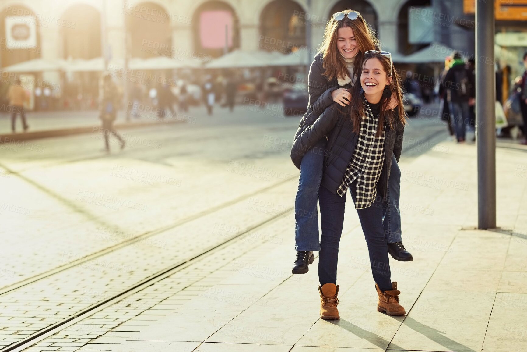 Buy stock photo Friends, piggyback and outdoor portrait in city, bonding and travel to Berlin on weekend trip. People, together and games on vacation in urban town, laughing and love in sisterhood or relationship