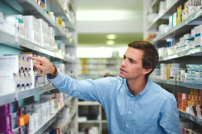 Buy stock photo Man, shelf and shopping in pharmacy for medicine, customer and medical product with prescription. Male person, search and reading label in chemist for health supplements, choice and healthcare pills