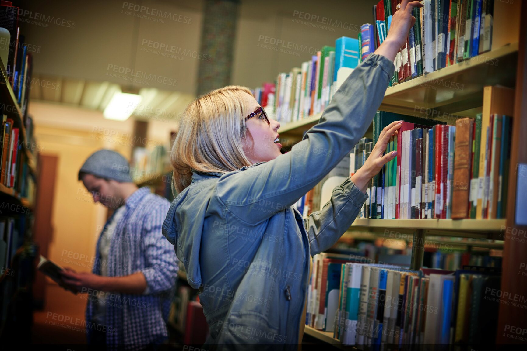 Buy stock photo University student, girl and book choice on shelf in library for learning, education or study. Woman, college and select textbook on bookcase for reading knowledge, literature research or information