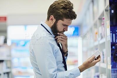 Buy stock photo Man, pharmacy and reading drug label on box, customer and search for antibiotics at drugstore. Male person, healthcare and aisle for medication shopping, info and apothecary to check side effects