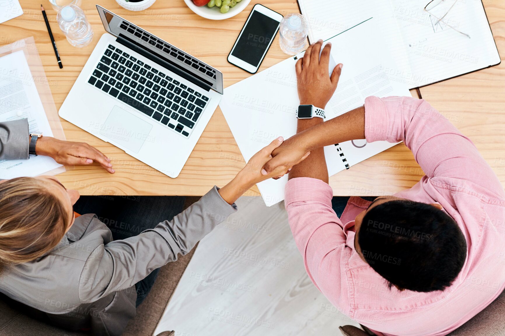 Buy stock photo Business people, handshake or above with colleague for partnership, meeting or agreement at office. Top view, employees or coworkers shaking hands for deal, greeting or teamwork together at workplace