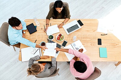 Buy stock photo Business people, designers and documents above with team in meeting for collaboration on table at office. Top view, employees or colleagues with paperwork for project planning or ideas at workplace