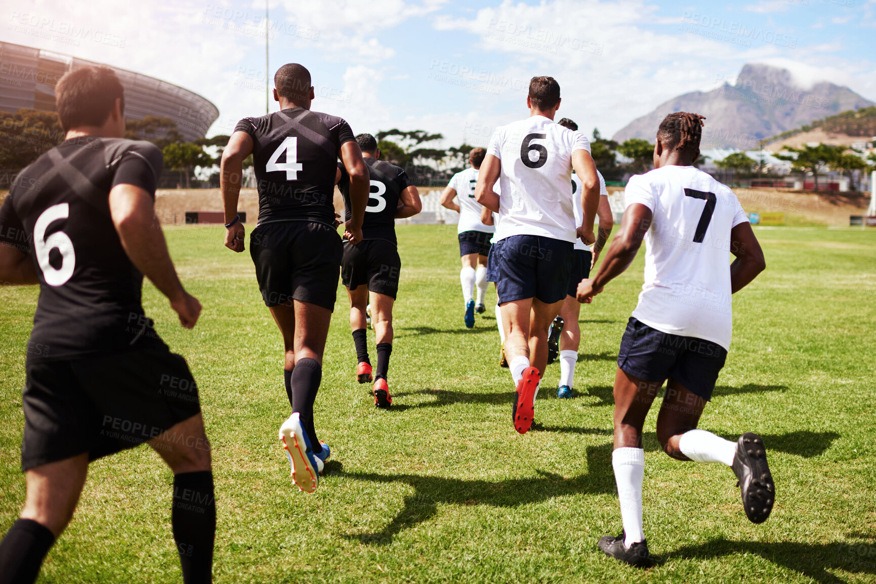 Buy stock photo Back, people and running on field for rugby, tournament and start of competitive game on grass. Sport, fitness men or team at stadium for competition, match or community challenge in outreach program