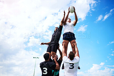 Buy stock photo Men, blue sky and rugby ball for jump, outdoor and challenge in exercise, wellness and fitness. Male people, athlete and recreation facility as team for match, sports and training in stadium or arena