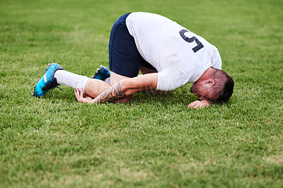 Buy stock photo Man, sport and knee injury with grass field for emergency, medical attention or accident in nature. Male person, athlete or rugby player with pain, joint inflammation or leg sprain at outdoor game