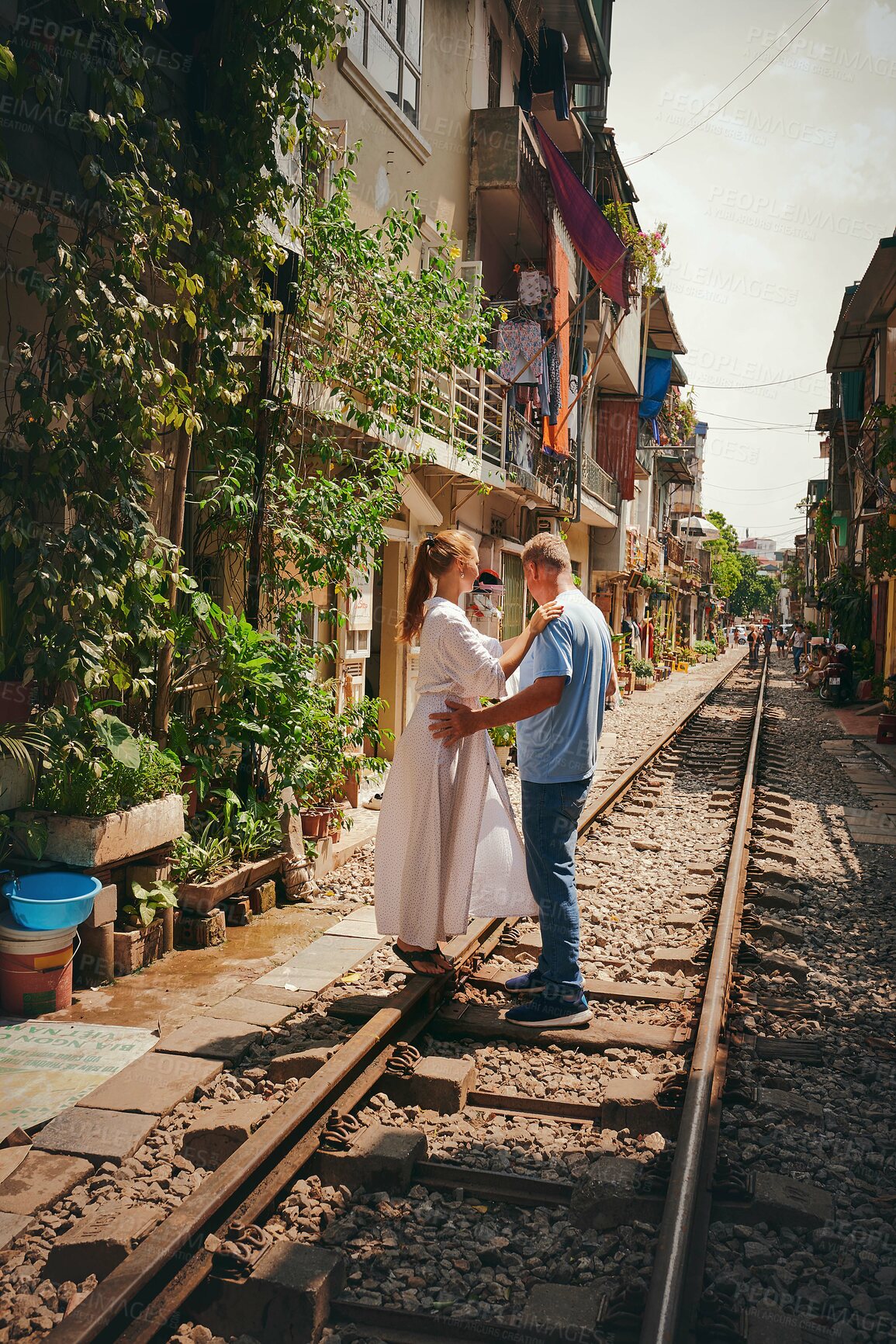 Buy stock photo Travel, couple and romantic holiday on train track for honeymoon adventure, hugging or sightseeing Vietnam. Tourist, people and exploring destination for vacation or relationship getaway with bonding