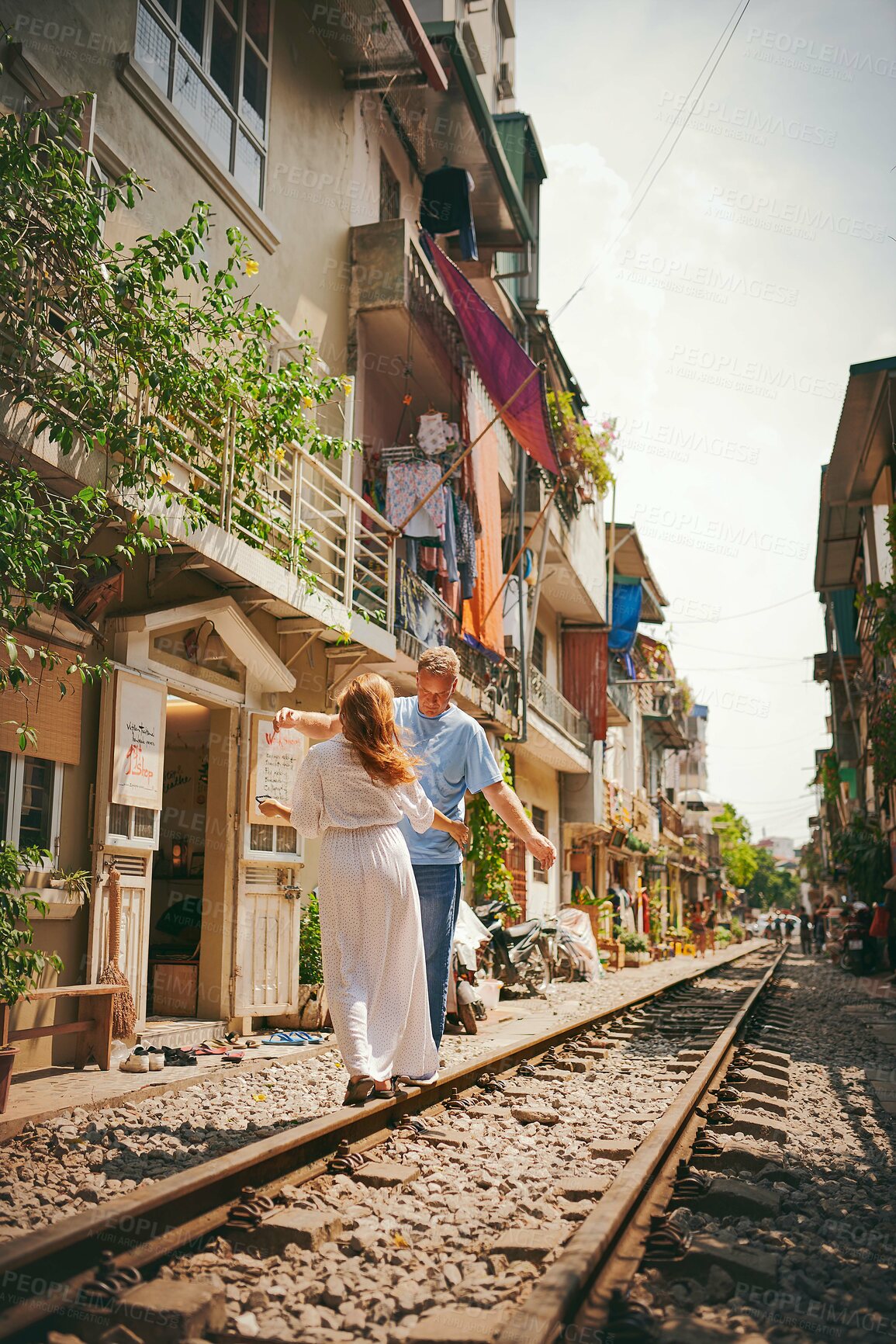 Buy stock photo Travel, couple and romantic holiday on railway track for honeymoon adventure, balance or sightseeing Vietnam. Tourist, mature man and explore destination for relationship vacation, bonding and love