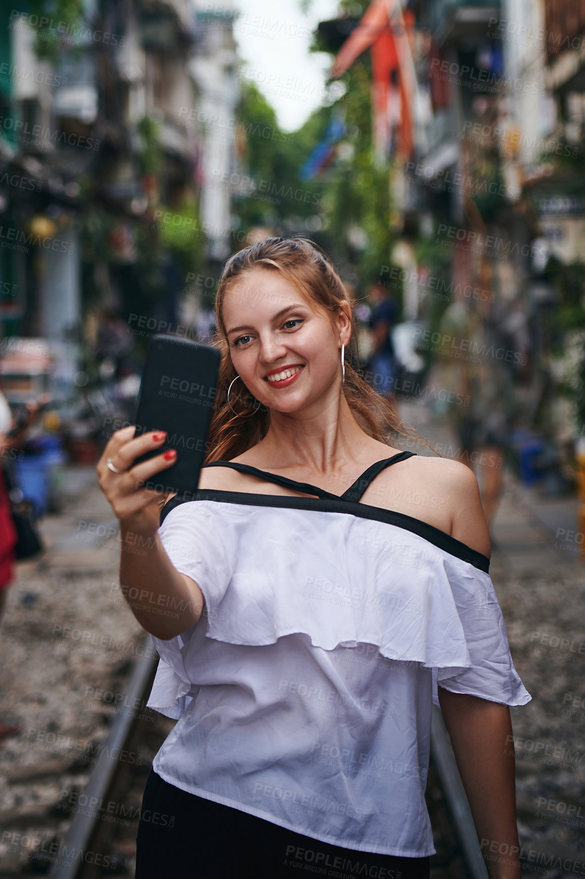 Buy stock photo Girl, selfie and smile for travel on train track, adventure or post on web for tourism in town. Woman, person and happy on railway for journey, photography and live stream on social media in Germany