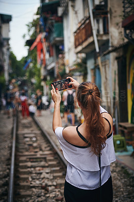 Buy stock photo Girl, selfie and outdoor for travel on train track, adventure or post on web for tourism in city. Woman, person and back on railway for journey, photography or live stream on social media in Thailand