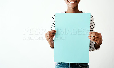 Buy stock photo Happy woman, hands and poster at studio mockup for announcement, information and promotion. Girl, paper sign and smile on white background space for presentation, billboard and advertising brand