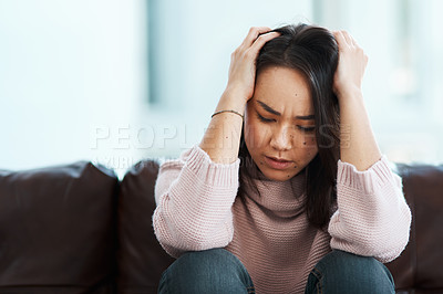 Buy stock photo Woman, anxiety and thinking on sofa with stress, trauma or mental health in home. Girl, holding head or lonely on couch with depression, fear or regret for bad memories with PTSD, sad or broken heart