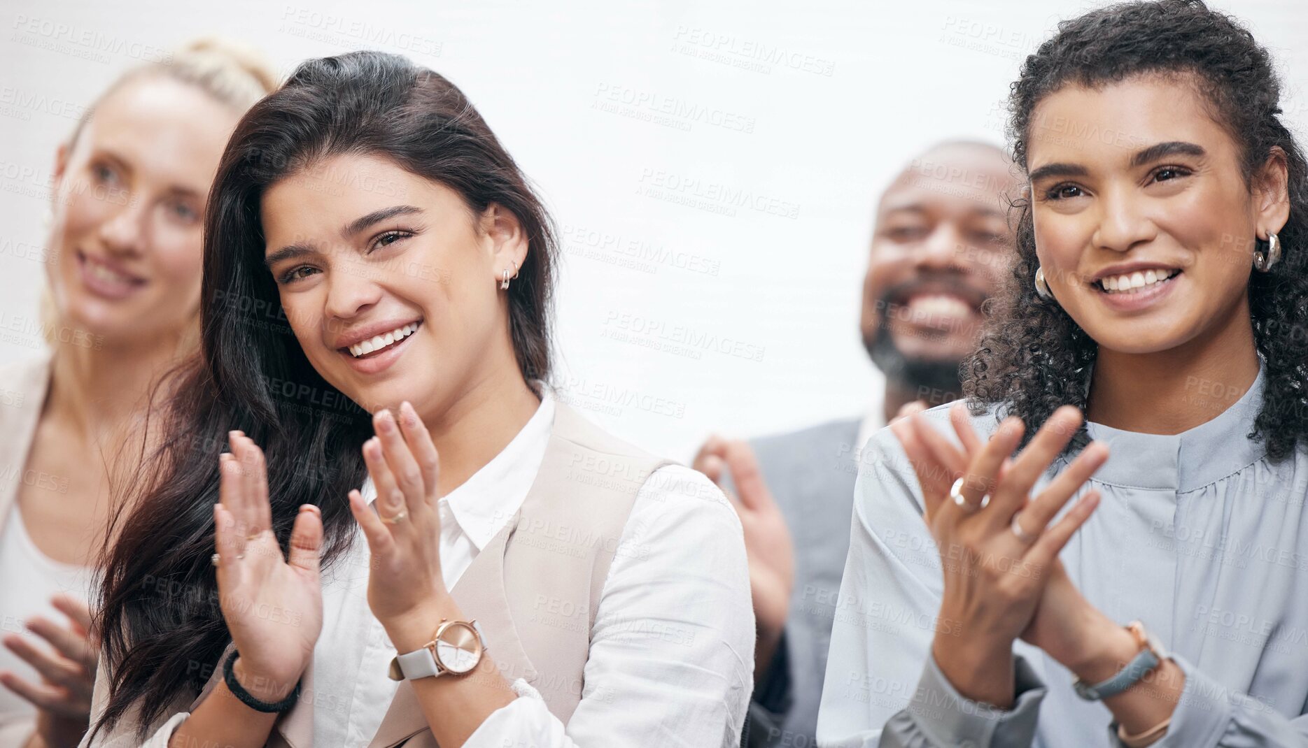 Buy stock photo Cropped shot of two attractive young businesswoman and their colleagues applauding while attending a seminar in the boardroom